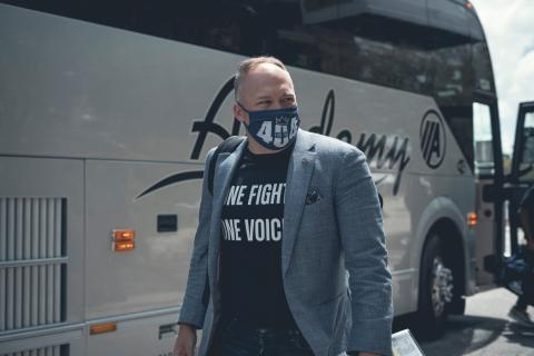 Football Coach Geoff Collins sport a face covering.