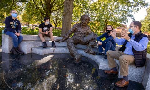 ECE Professor Bernard Kippelen (far right) with his students at the Einstein statue.