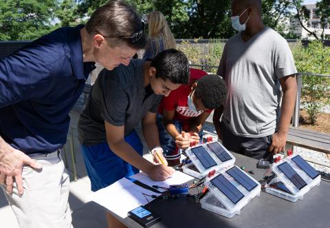 Students of the 2021 "Energy Unplugged" summer STEAM camp recording data from a small solar test kit.