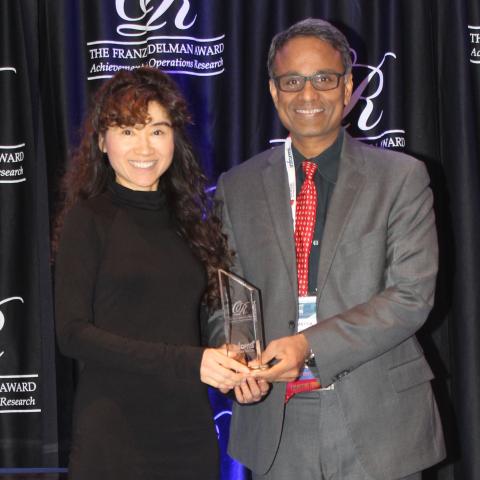 Professor Eva Lee accepts the Edelman Academy trophy on behalf of ISyE and Georgia Tech.