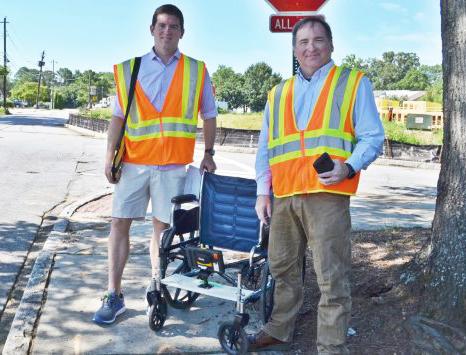 GT Professor Randal Guensler and grad student Daniel Walls demonstrating their wheelchair based sidewalk survey rig.