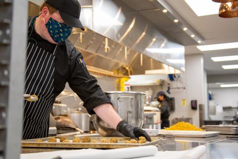 Photo of Houston Freeman prepping food in one of the Tech Dining kitchens.