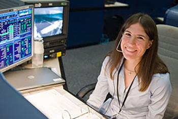 Heidi Brewer at a console at NASA's Johnson Space Center.