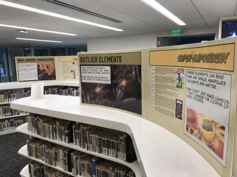 Exhibit posters detailing the use of elements in science fiction