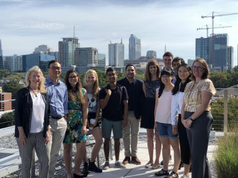 A photo of The Georgia Tech JUMP into Stem finalists pose with Omar Asensio, Marilyn Brown, and researchers from the Oak Ridge National Laboratory.