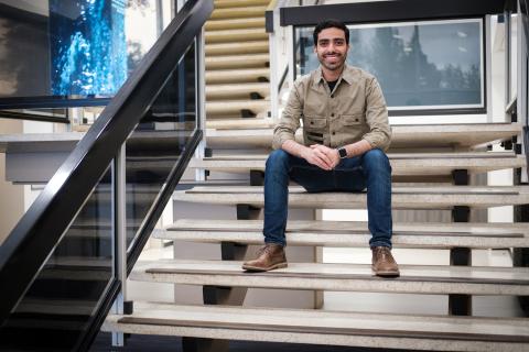 Joseph Anz sitting on glossy white steps 