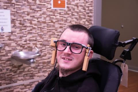image of man in wheelchair with magtrack technology on his head 