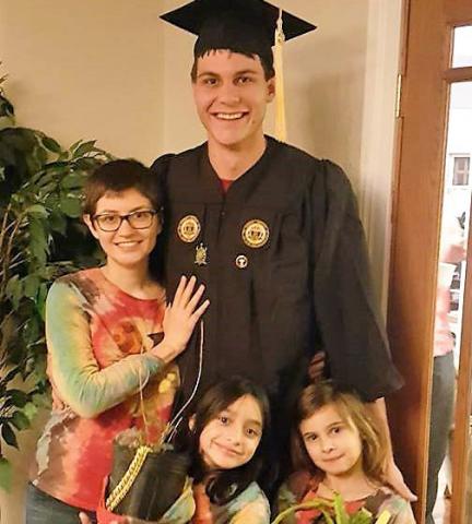 Mars Berwanger celebrates graduation with current electrical engineering major Anna Harrison and his nieces Britain and Haleah (from left to right).