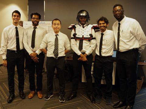 Omojaro (far right) poses with his senior design team at the Capstone Expo. 