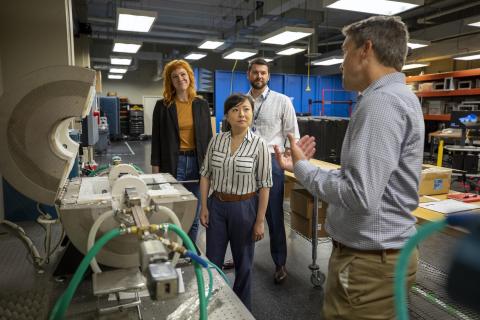 David Reid demonstrates the function of the high=temperature cavity waveguide system for measuring the complex permittivity of different radome materials. (L to R):  Aimee Williams, Ellen Yi Chen Mazumdar, Kenneth Allen, and David Reid. (Photo credit: Sam McNeil, GTRI)
