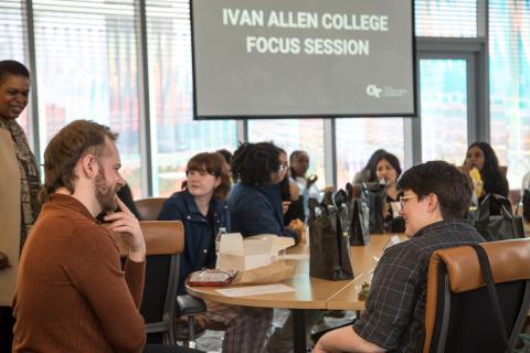 Graduate student Ben Wills talks with other Georgia Tech students
