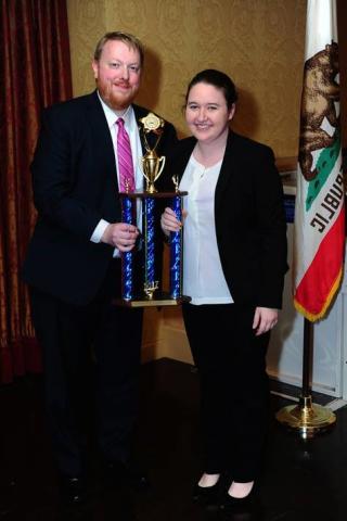 GTMT President and Captain, Sarah Stebbins, receives the 2nd Place trophy from AMTA Representative, Mr. Johnathan Woodward.