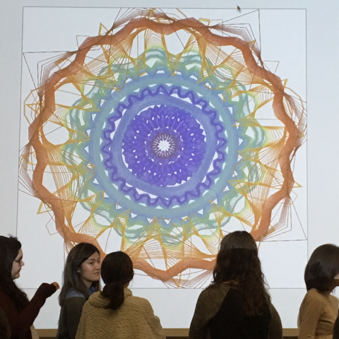 Students standing around a projection of DILAC's Heart Sense project.