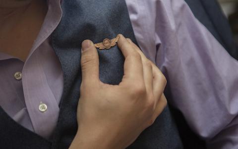 Matthew Gombolay holds his certified flight wings from the FAA