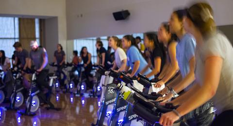 People on bikes in a spin class