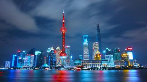 Shanghai, China skyline lit up at night.