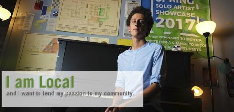 Yonatan Weinberg sitting at a piano with the words "I am Local" in the corner