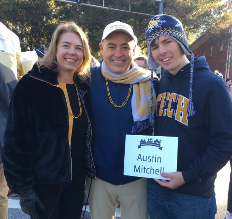 Austin Mitchell poses with President Cabrera and his wife, Dr. Beth Cabrera at the Wreck Parade.