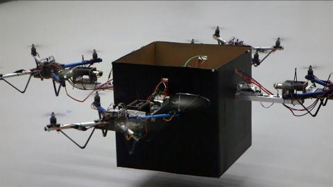 Four drones lift a 12-pound package