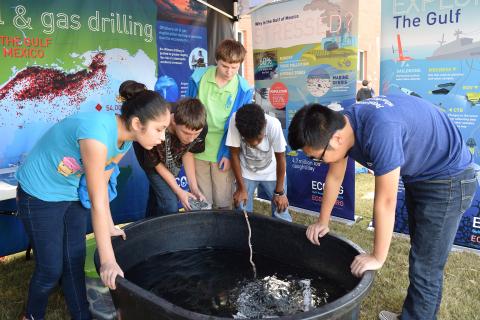 Cowan Road Middle school 7th graders control remotely operated underwater vehicle at ECOGIG Exhibit.