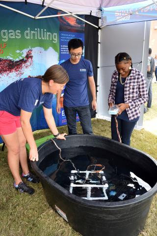 Emily Davenport - UGA, ECOGIG demonstrate remotely operated underwater vehicle at ECOGIG Exhibit.