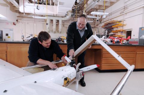 Mike Heiges (right) adjusts GTRI’s Airborne Unmanned Sensor System (GAUSS)