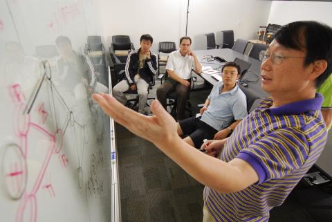 Professor at White Board With Students