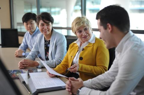 Graduate students talking to a career advisor