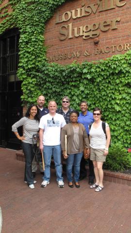 A group of students in front of Louisville Slugger during weekend excursion