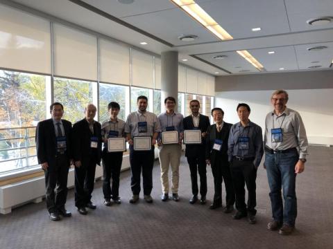 photo of Karan Mehta (4th from right) with ISSLED student award winners and conference organizers