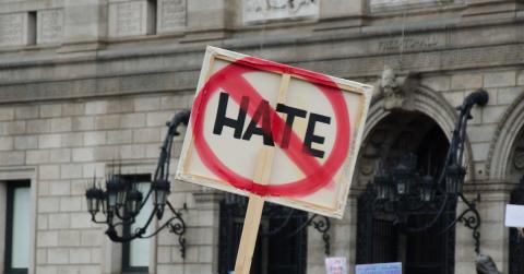 hate crossed out on a picket sign