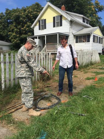 Researcher and military replace a pipe.