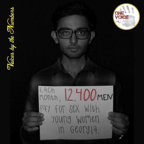 Suraj Sehgal with a Sign About Sex Trafficking