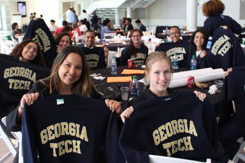 students holding Georgia Tech sweatshirts