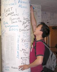 Students signing lab wall
