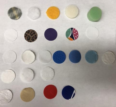 Mask fabric samples cut in circles on a white background