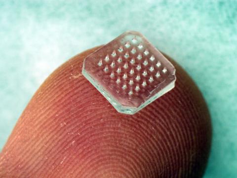 Dissolving microneedles on fingertip