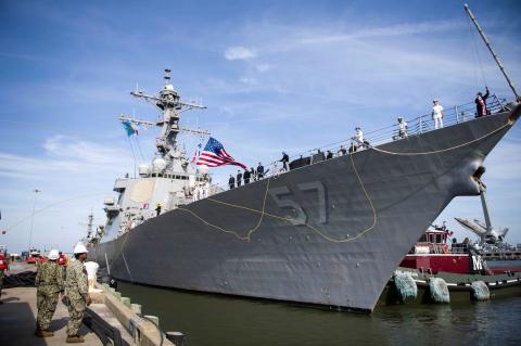 A photo of Sailors assigned to the guided-missile destroyer USS Mitscher (DDG 57) throw shot lines to the pier to prepare for mooring as the ship returns to Naval Station Norfolk, May 5, 2019, after a seven-month deployment to the U.S. 5th and 6th Fleet areas of operations. The ship deployed to ensure maritime stability and security.