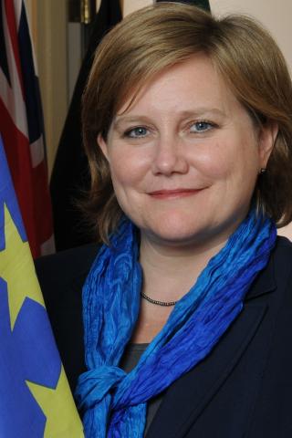 Portrait photo of Vicki Birchfield with EU flags