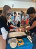 Anna Doll, education curator at the Robert C. Williams Museum of Papermaking, guiding visitors as they make paper.