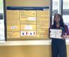 Harika Kosaraju smiling next to a research poster, holding an award that says "Most Outstanding Project"