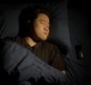 Georgia Tech Associate Professor W. Hong Yeo is shown sleeping  with the wearable sleep apnea detection and sleep quality monitoring device he and a team of researchers and clinicians created.