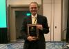 Photo of ECE Professor Deepakraj Divan holding the 2023 Nari Hingorani Custom Power Award plaque.