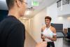 Belinda Person assists Shenghan Wu with onboarding at the Administrative Services Center. 