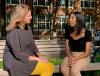 Two women sit and talk on a park bench
