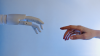 a robot hand reaching out to a human hand