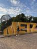student in front of letters spelling METZ