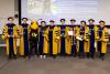 Mavris is flanked at the December 2023 ASDL Graduate Recognition Ceremony by the eight students who completed their Ph.D.s and Buzz.