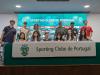 Group photo at table with Sporting Clube de Portugal banner.