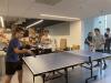 Two young men play ping pong.